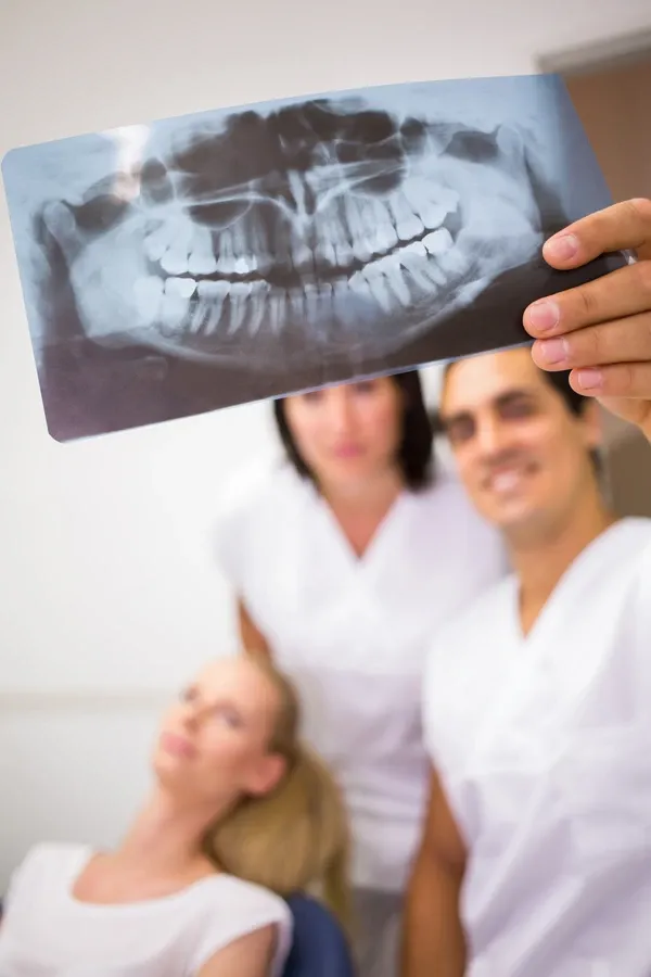 Mature Adult, Woman, Female, Caucasian, Mid Adult, Healthcare, Doctor, Practitioner, Dentist, Job, Aesthetic, Occupation, Professional, Medical, Specialist, Co-worker, Colleague, Health Service, Hospital, Clinic, Patient, Treatment, Orthodontist, X-ray, Report, Teeth, Discussing, Examining, Looking, Checking, Analyzing, Test, Plate, Care, Hygiene, Radiologist, Radiodentist, Radiography