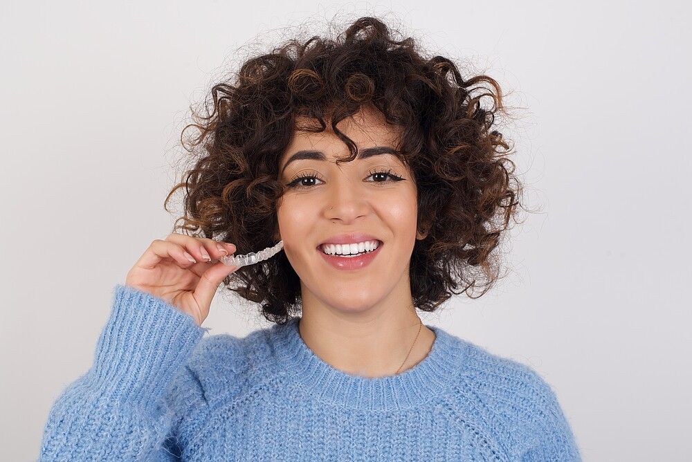 african, brunette, cute, gorgeous, studio, woman, female, girl, curly hair, arab, latin american, aligners, plastic, hand, patient, healthcare, beautiful, bruxism, black, people, lifestyle, lips, care, healthy, dentist, tooth, teeth, dental, transparent, braces, aligner, invisible, dentistry, orthodontic, mouth, health, equipment, orthodontics, oral, background, whitening, clear, hygiene, white, invisalign, guard, beauty, medical, open
